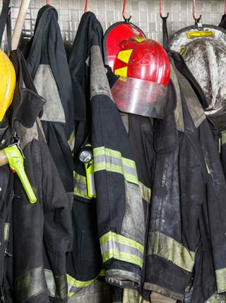 dirty firefighting gear hanging up